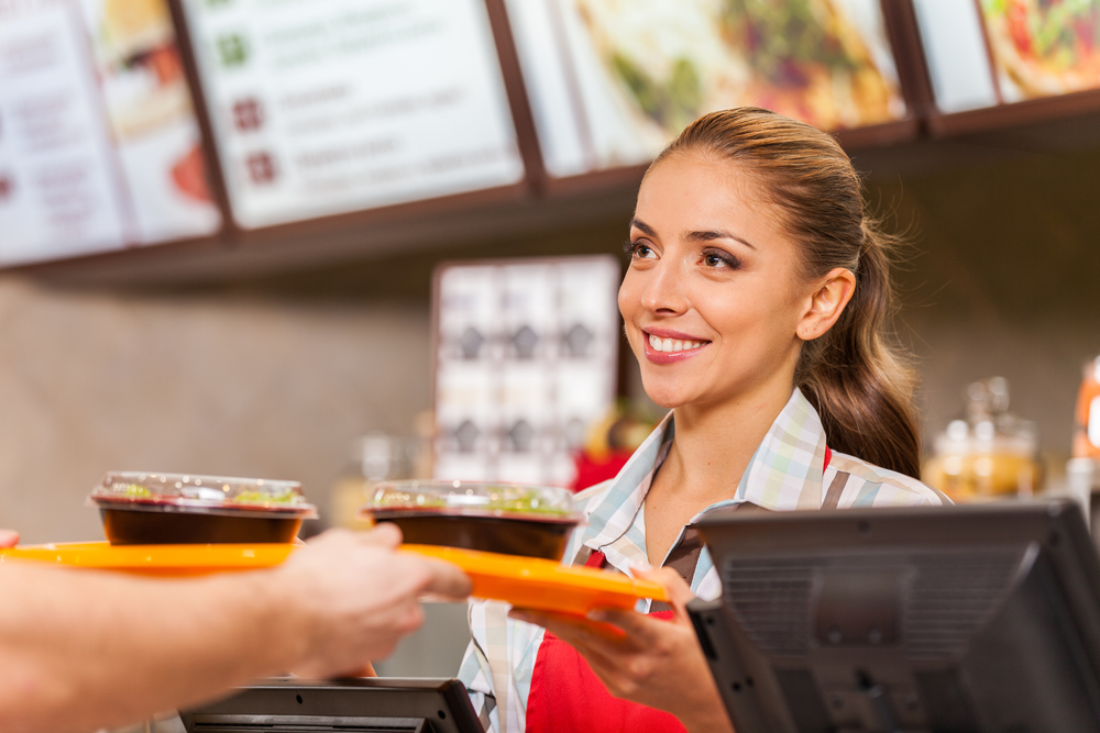 Restaurant worker serving two fast food meals